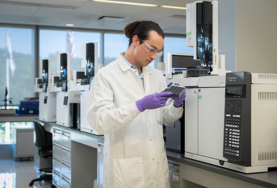 Scientist examining analytical samples in a laboratory for leachables. 