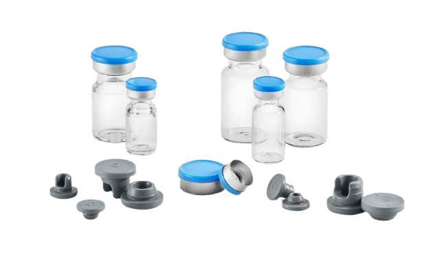 West stoppers, seals, and vials on a clean surface.