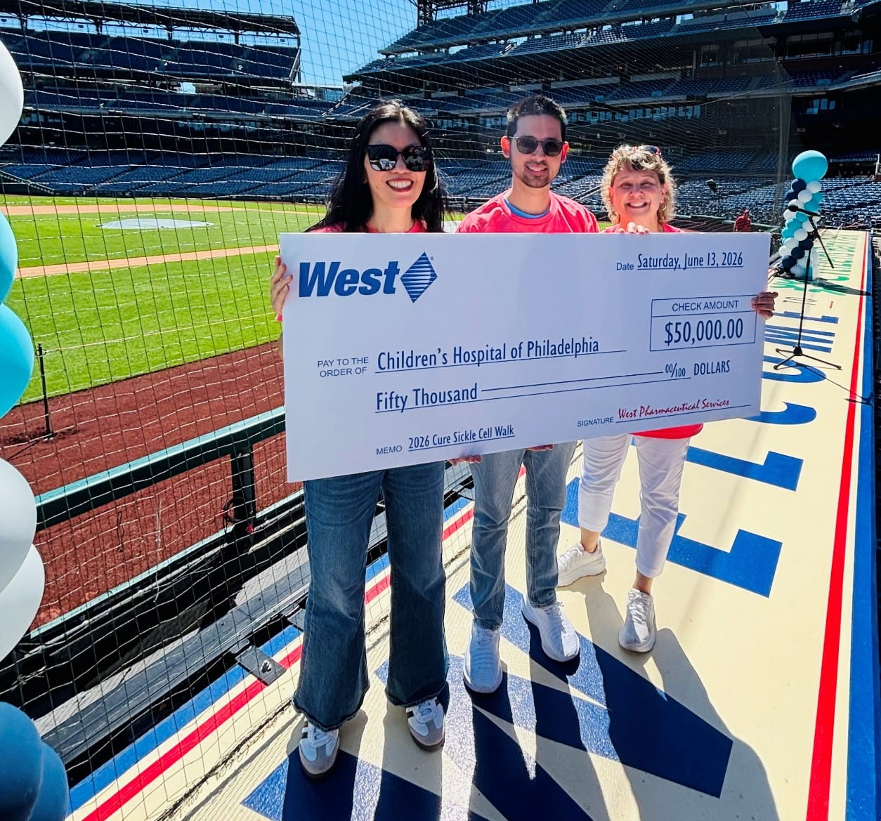 West employees presenting a $50,000 donation check at the 2026 Cure Sickle Cell Walk event.