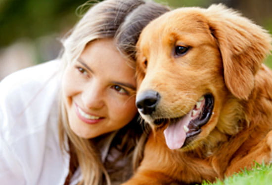 A girl smiling with her dog