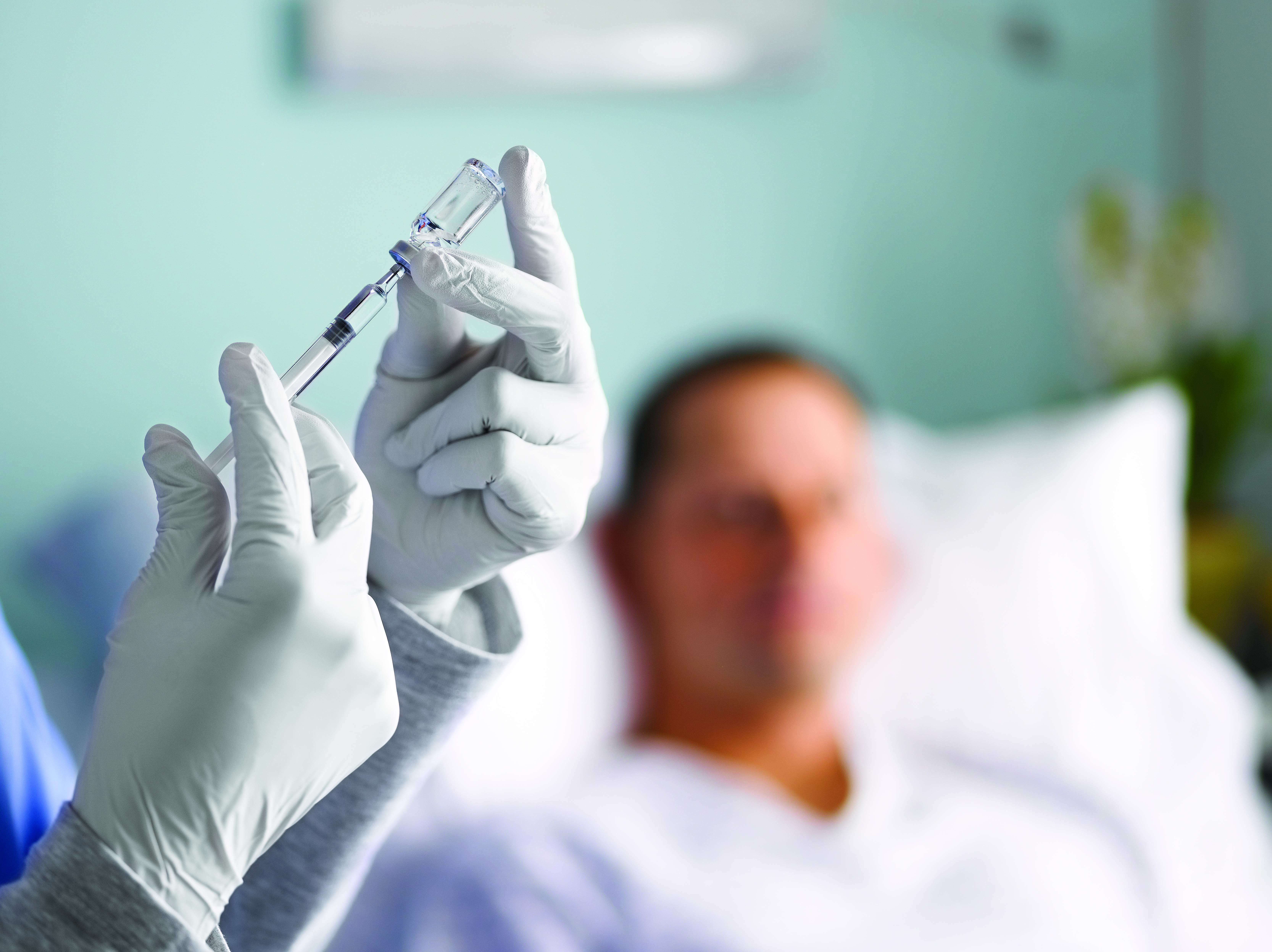 Nurse extracting medication pictured in a webinar page on regulatory frameworks for combination products.